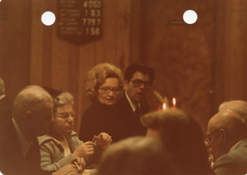 A group of congregants sit around a table