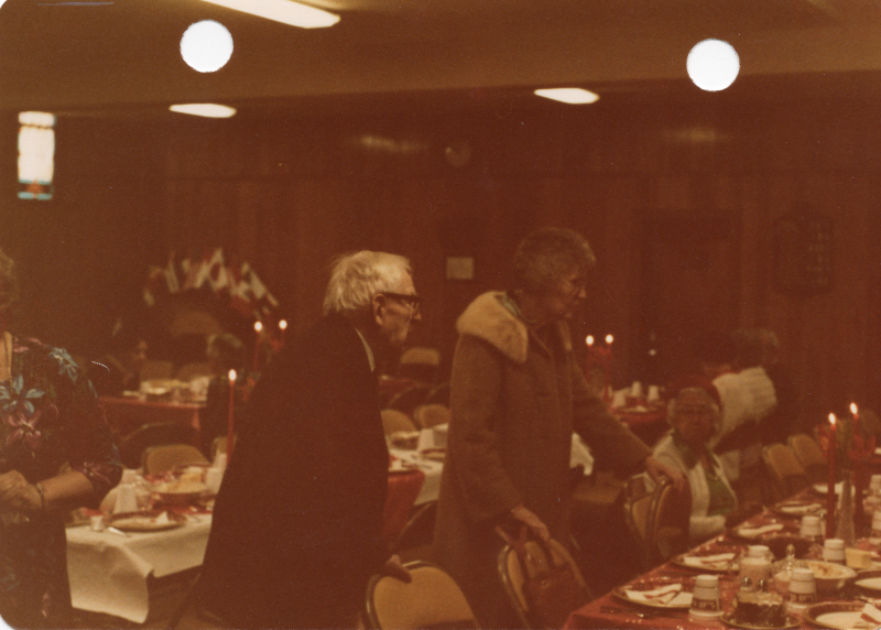 Two people stand at a table