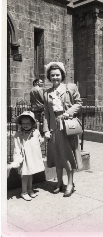 A mother and daughter smile together outside of the church at 19th and Green streets