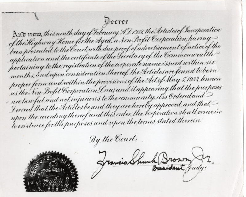 Judge Francis Brown signs the official decree that establishes Highway Home for the Aged's non-profit organization status