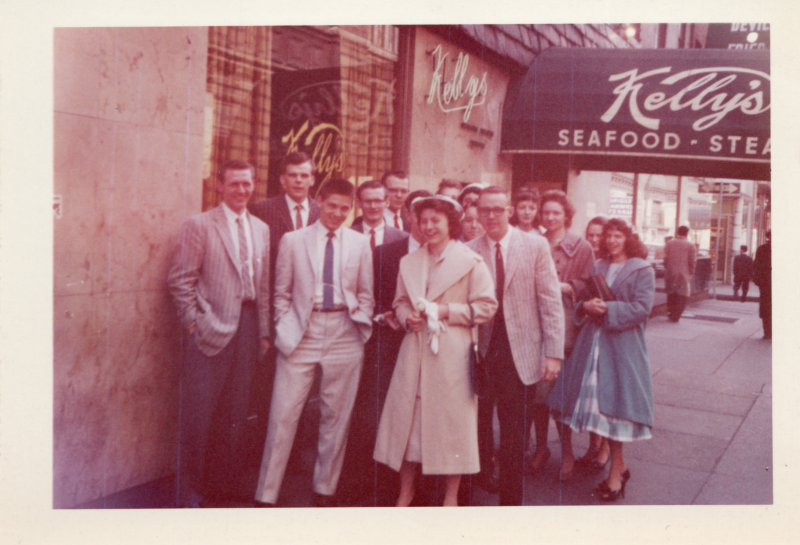 A group of young men and women smile togetger outside Kelly's Seafood and Steak