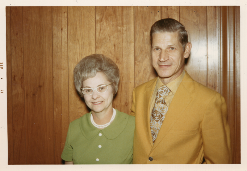 A man and woman smile together for a portrait