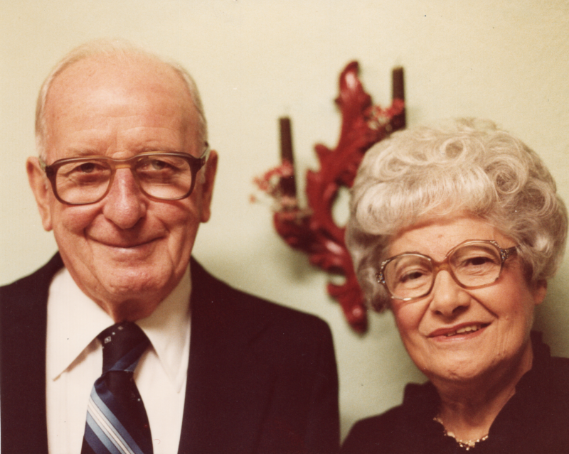 A man and woman smile together for a portrait