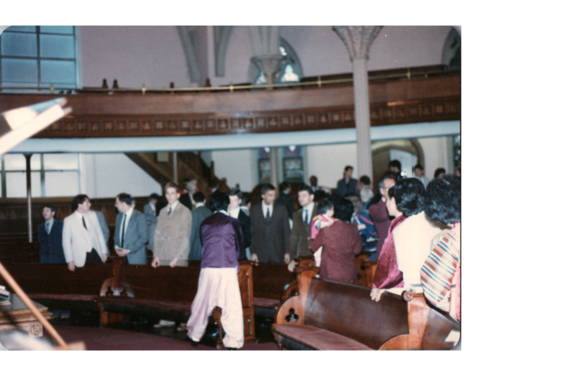 Photograph of congregants greeting each other, with a large group in traditional Korean clothing