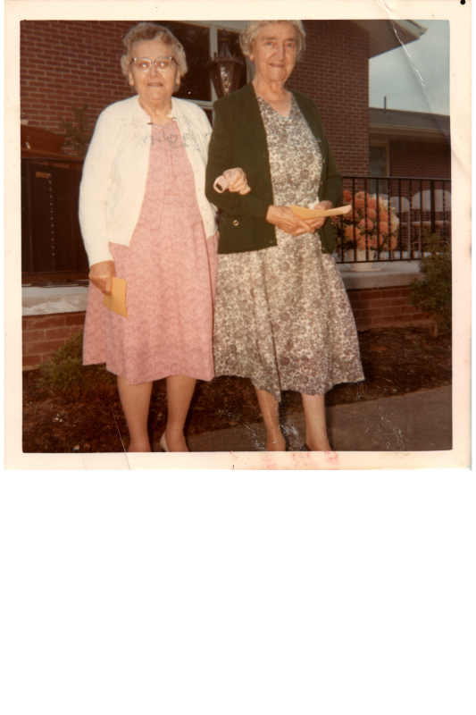 Two women pose for a portrait