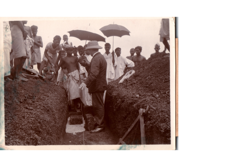 Brother Cook lays the foundation for missions headquarters and prays with a group of masons, workmen, and co-workers