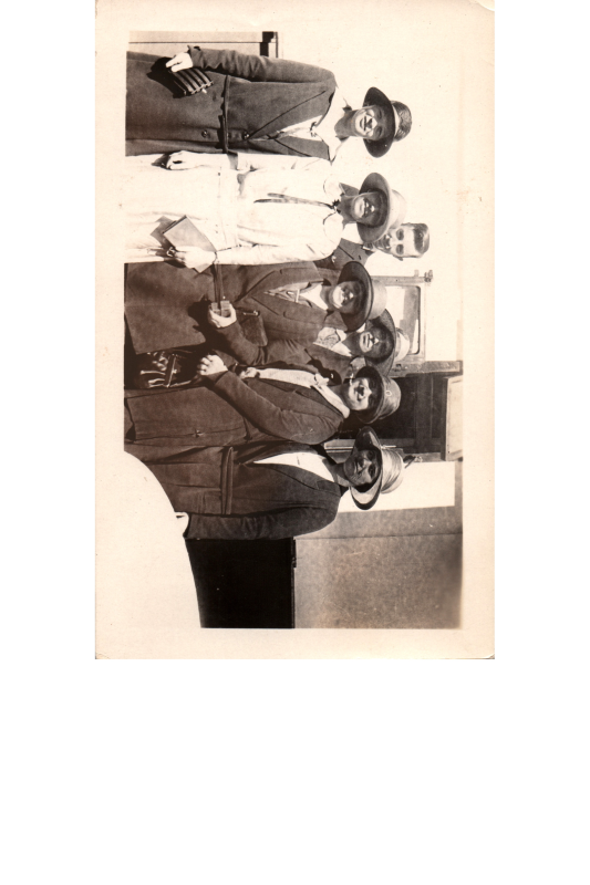 Six women and one man smile together for a portrait