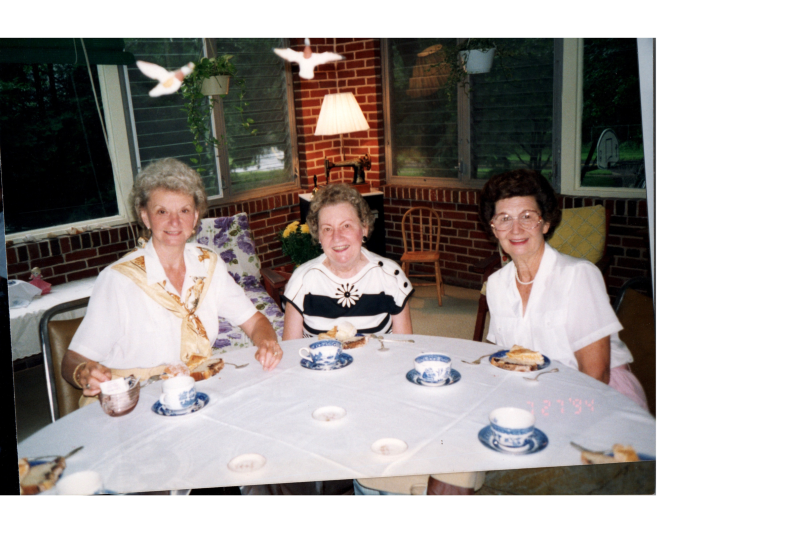 Three women smile together