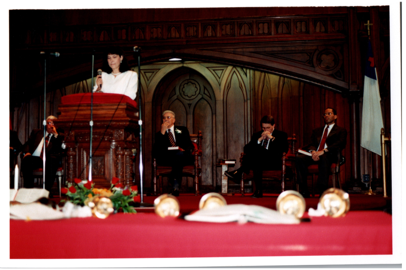 A woman speaks in the sanctuary