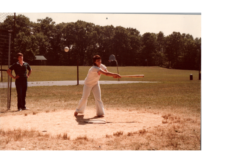 A woman hits a softball