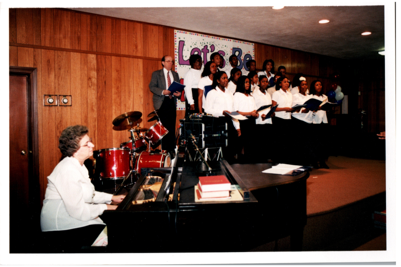 Choir performs with a piano accompanist