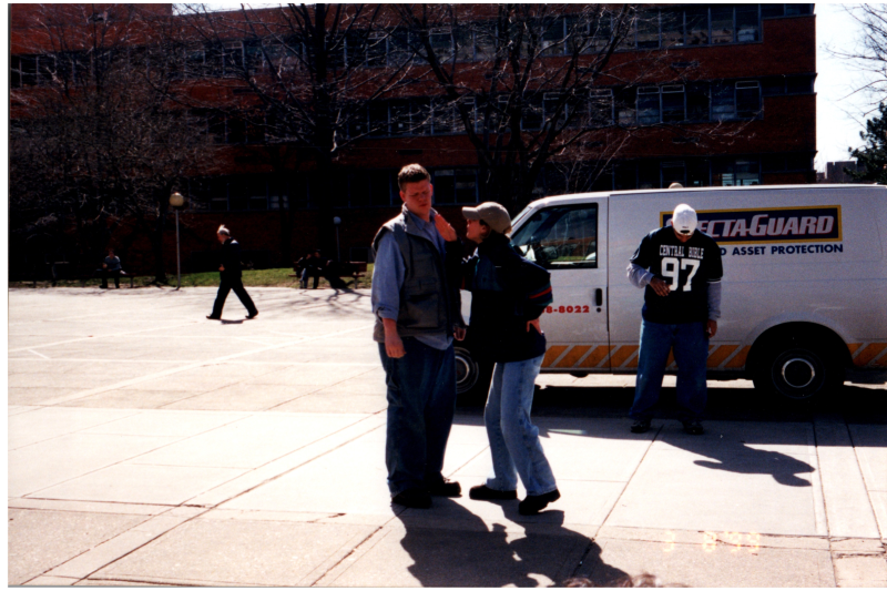 Group talks in front of a Specta-Guard van