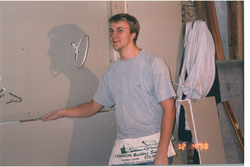 A man helps construct walls
