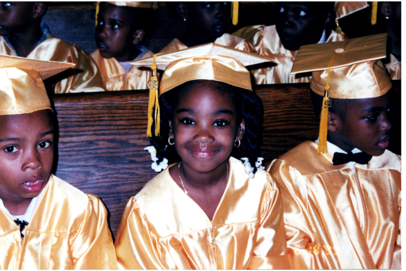 Graduates smile for a photo