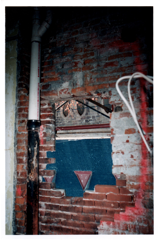 Opening in brick facing the church for a window