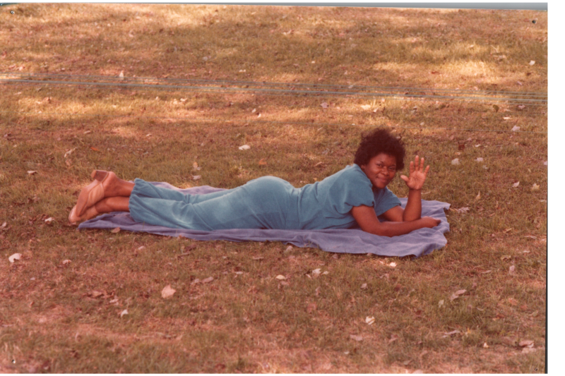 A woman lies down on a field