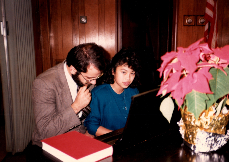 A man and woman play the piano