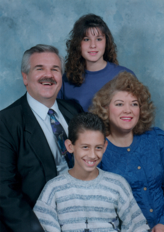 A man, woman, boy, and girl smile together