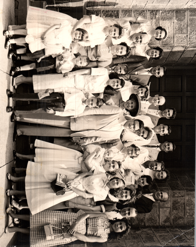A group of congregants smile together outside of Highway