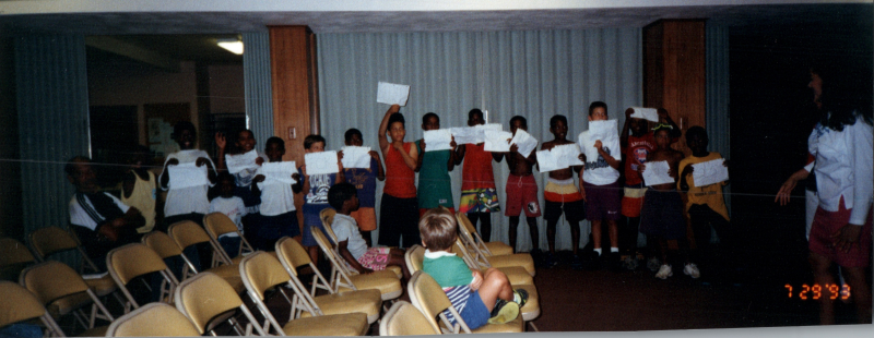 Children hold up papers