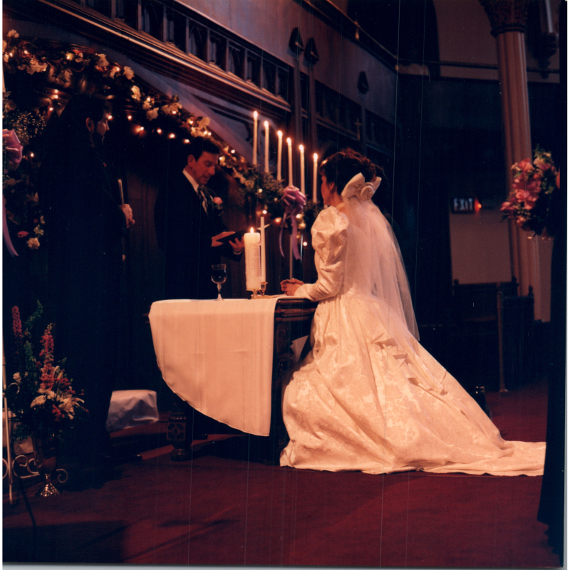 A bride kneels