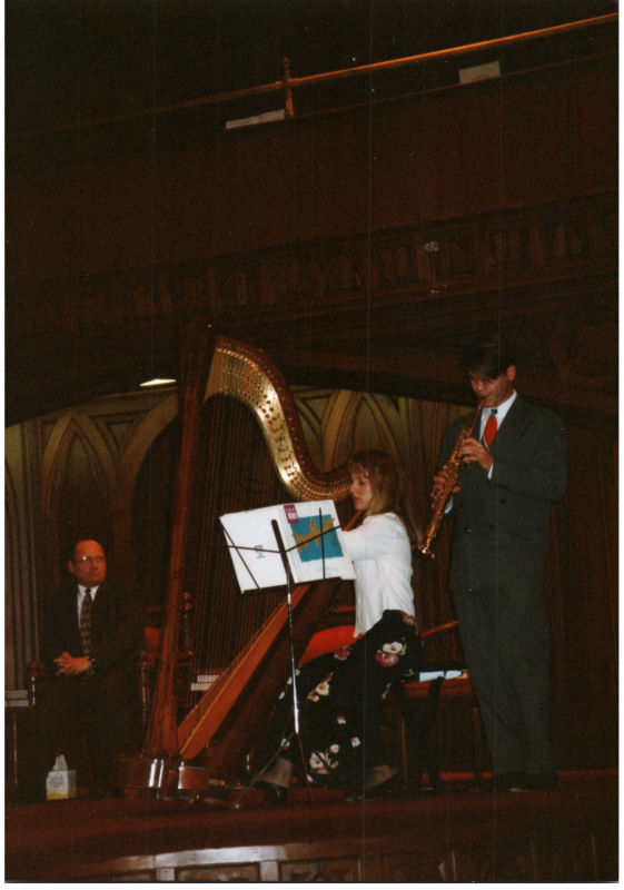 A woman plays the cello while a man plays the oboe
